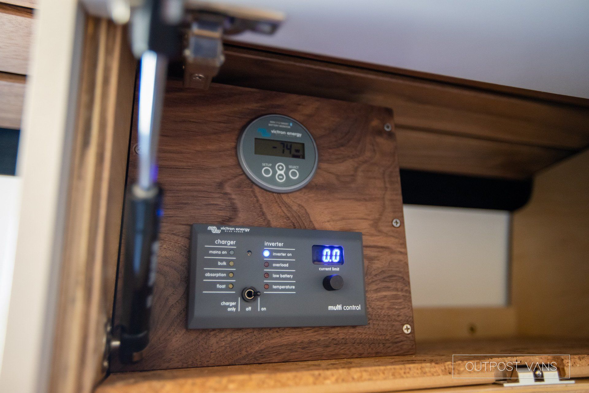 A wooden box with a digital clock on top of it.