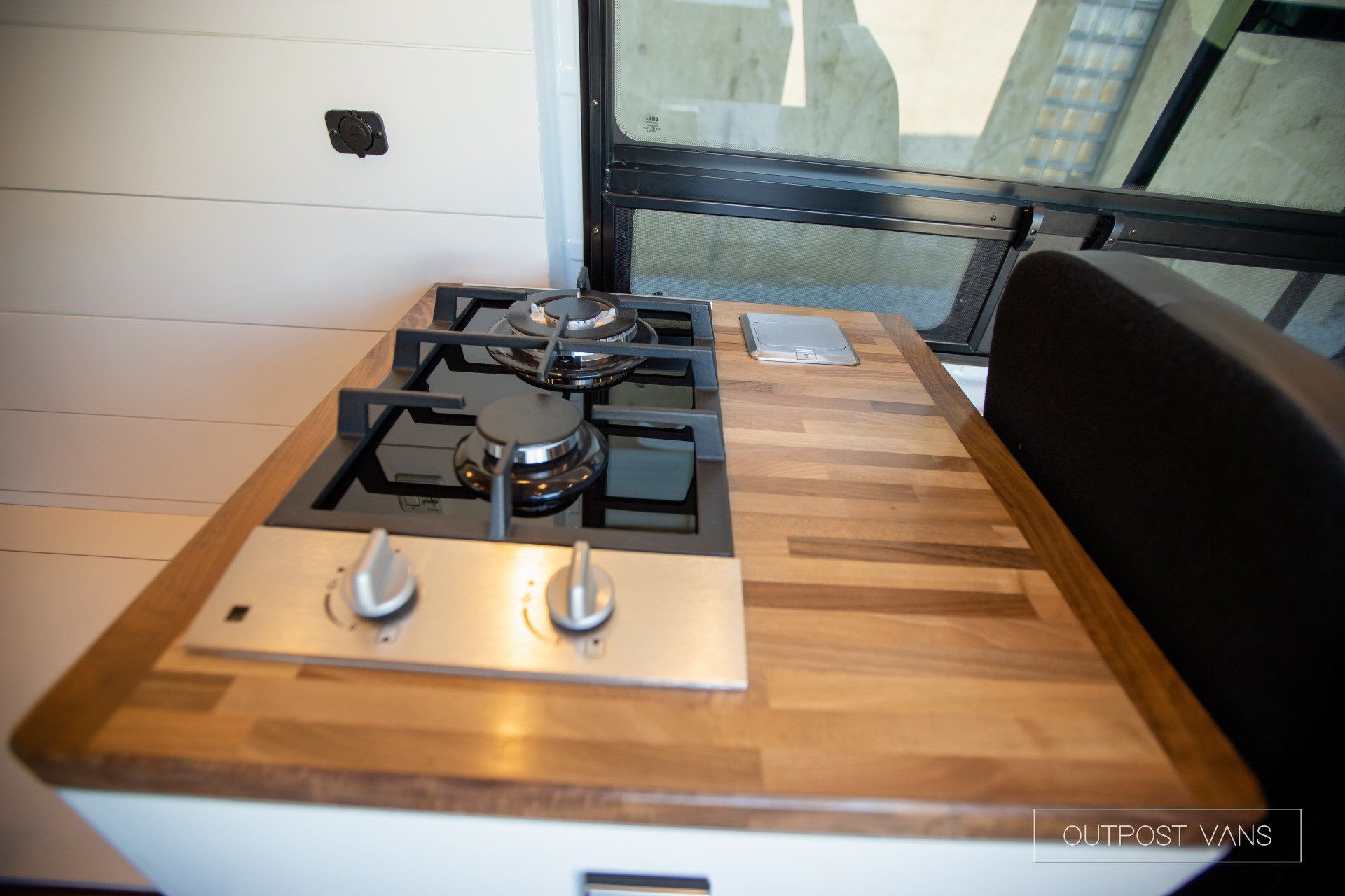 A stove top oven with a wooden counter top
