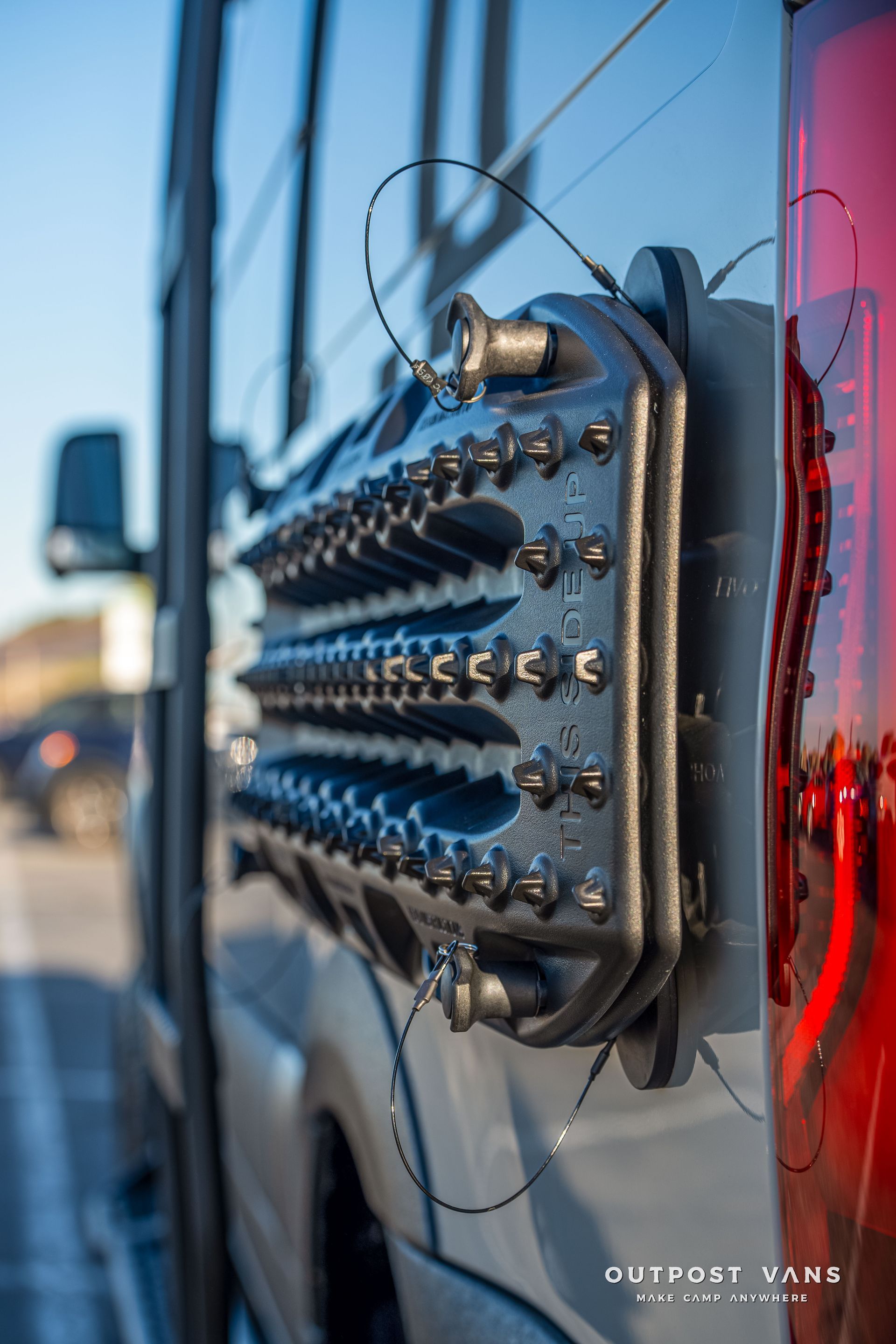 Black recovery track mounted on side of van.