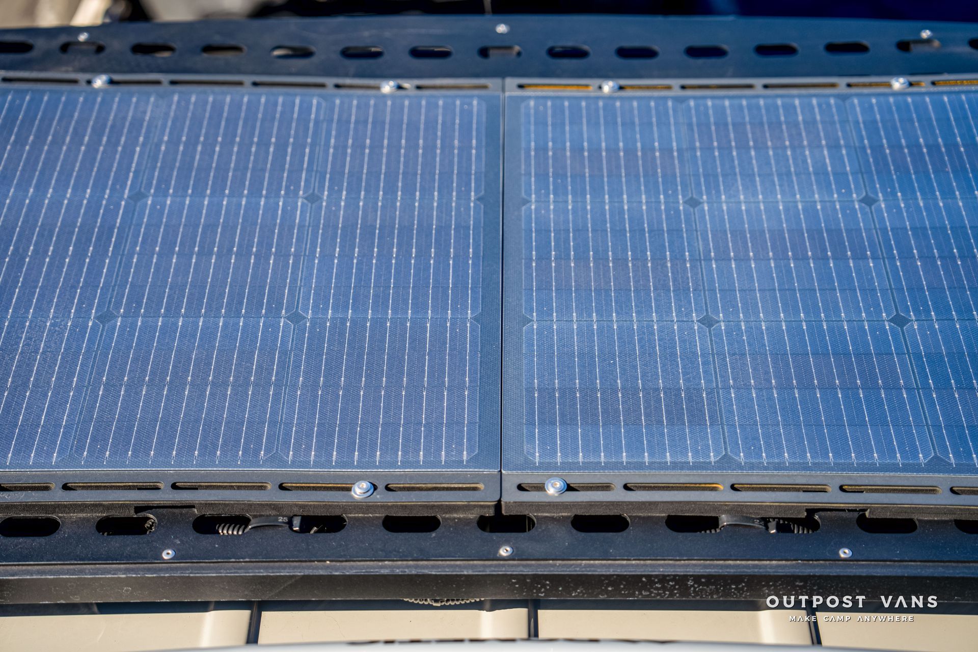 Two rectangular solar panels with a metal frame, mounted on a vehicle.