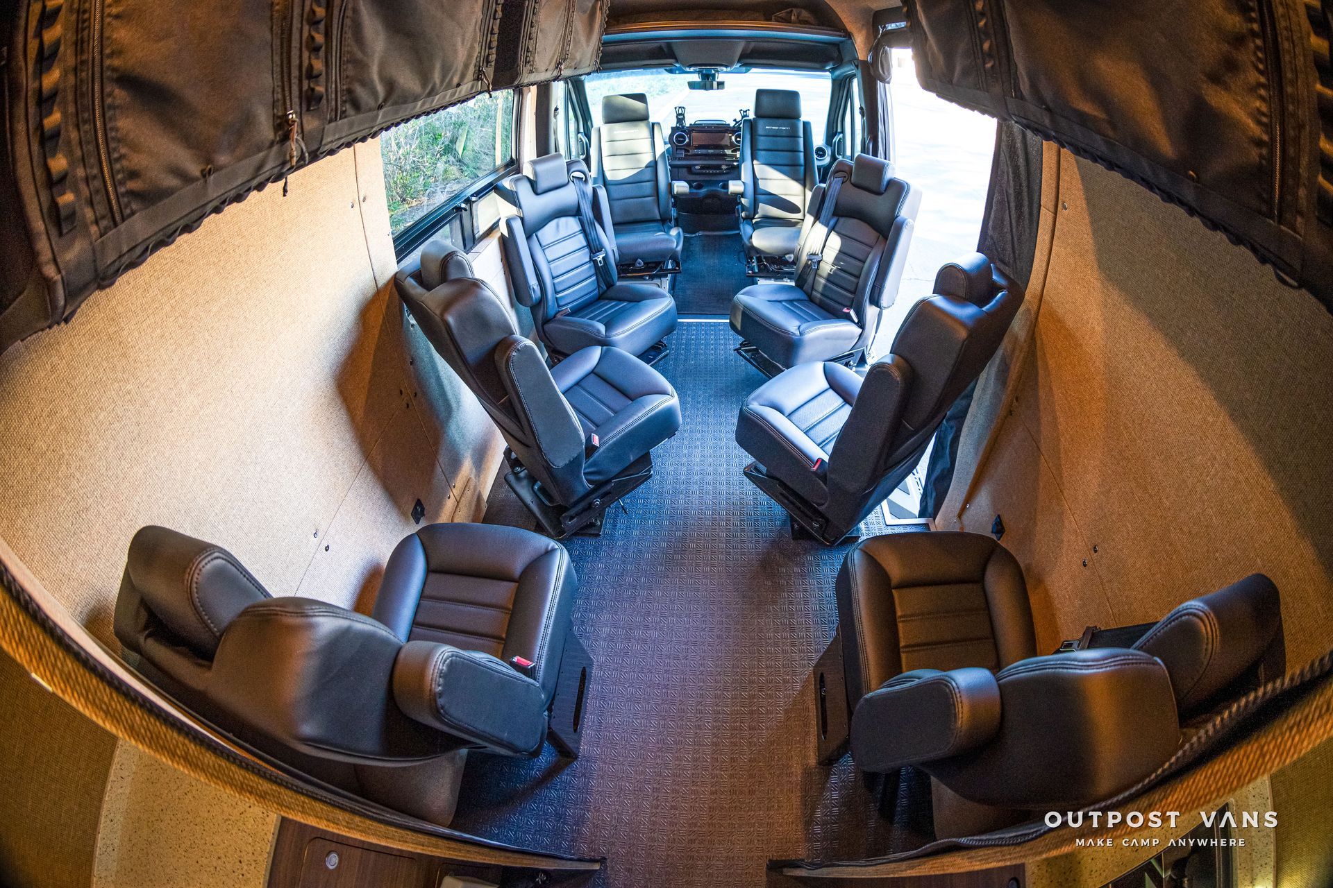 Interior view of a black luxury van with leather seating.