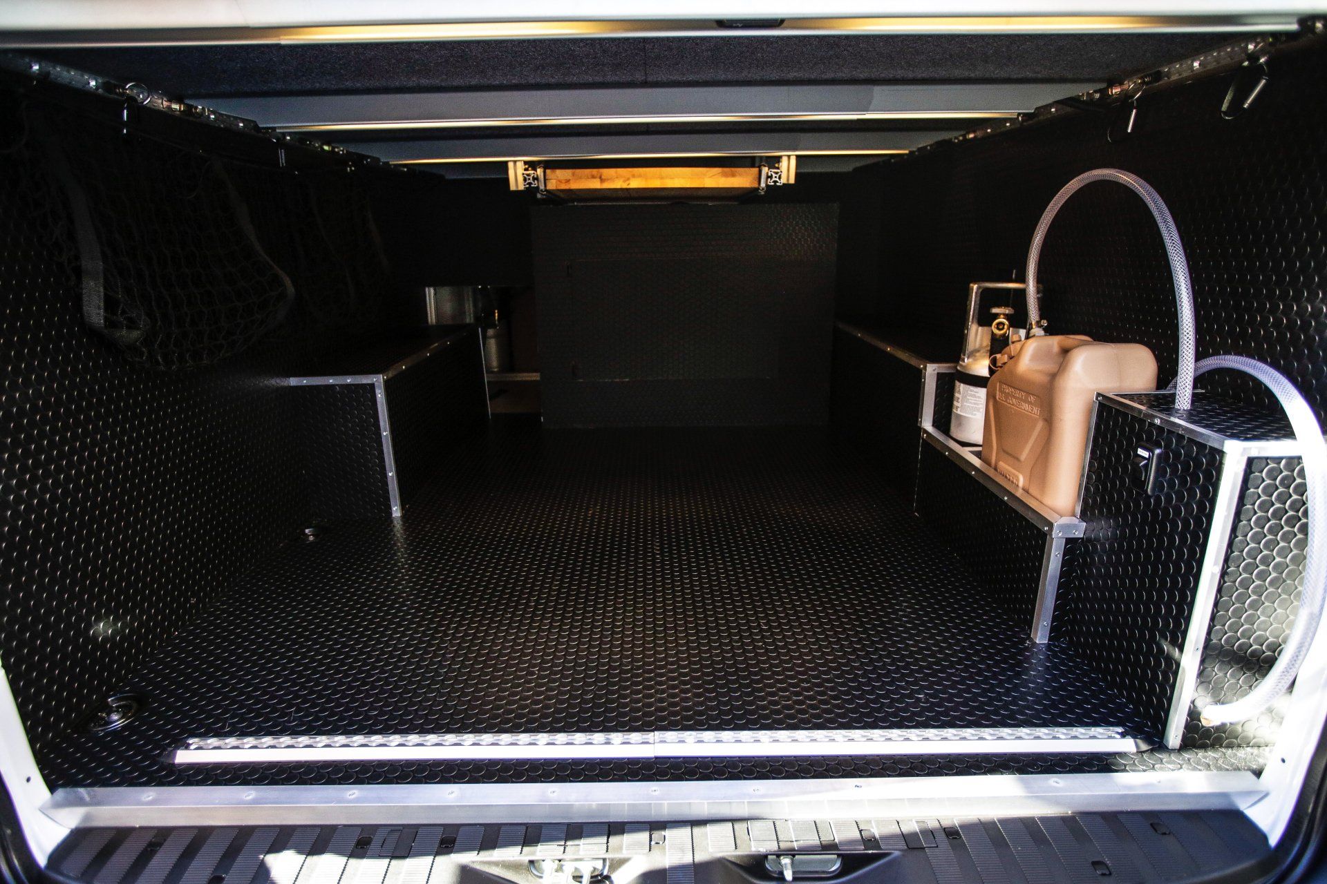 the trunk of a truck with a purse on the shelf