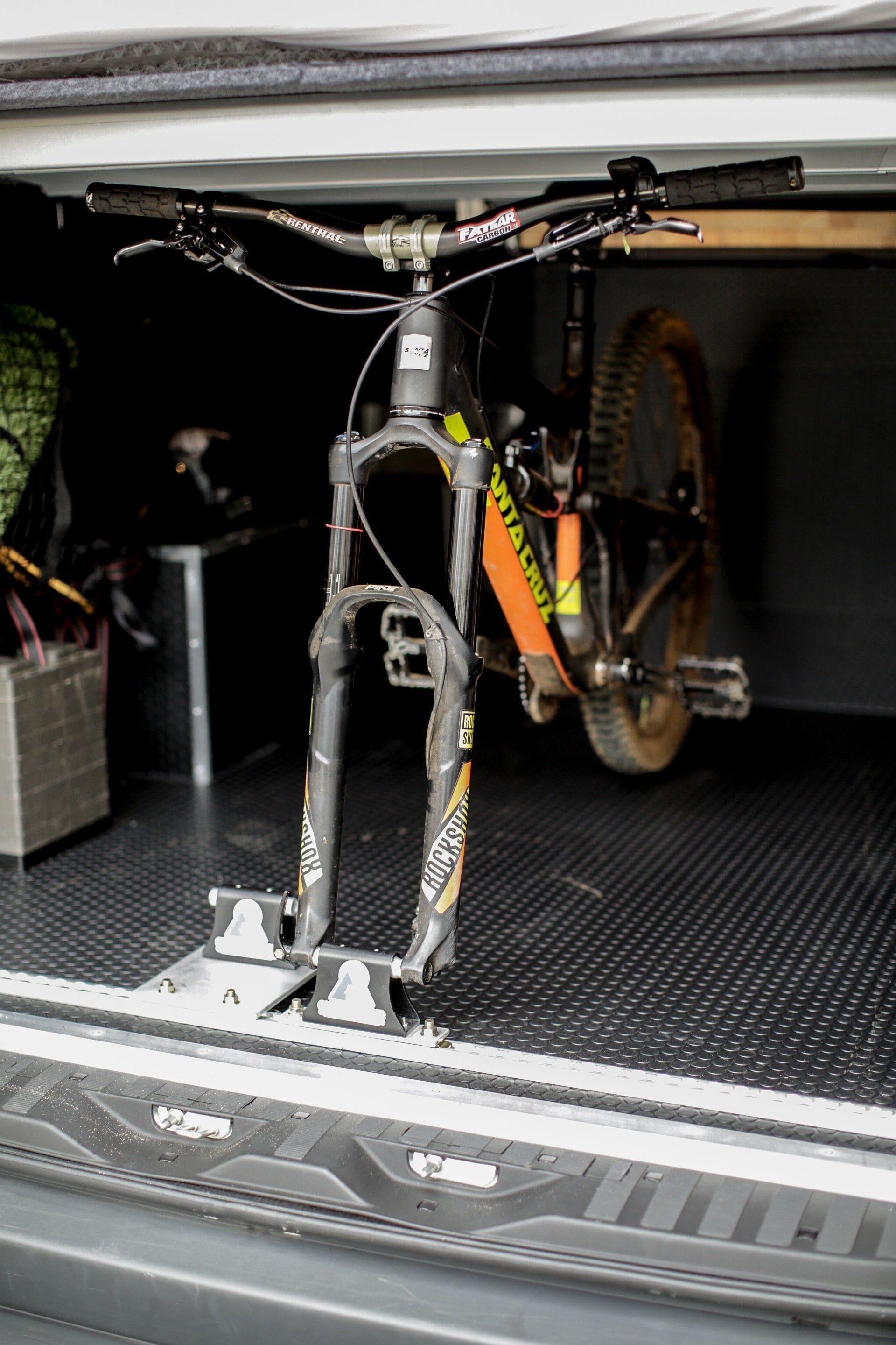 a bicycle is sitting in the back of a van .