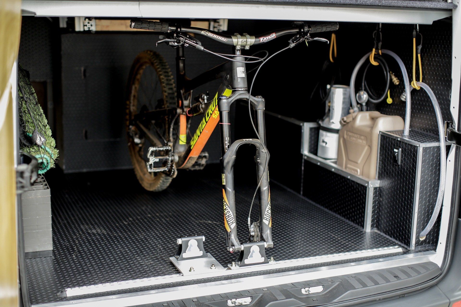 a bicycle is sitting in the back of a van .