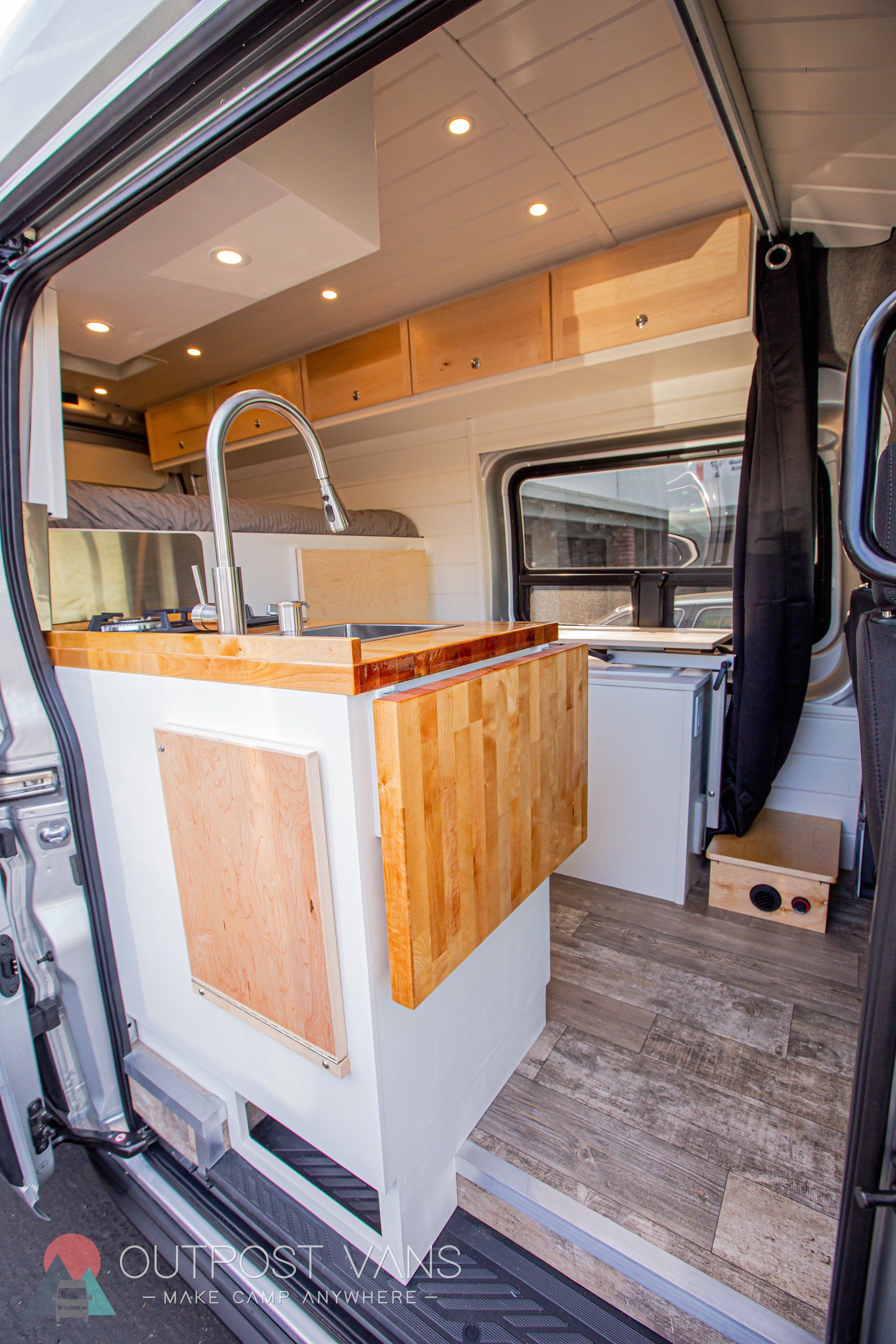 the inside of a van with a sink and a table .