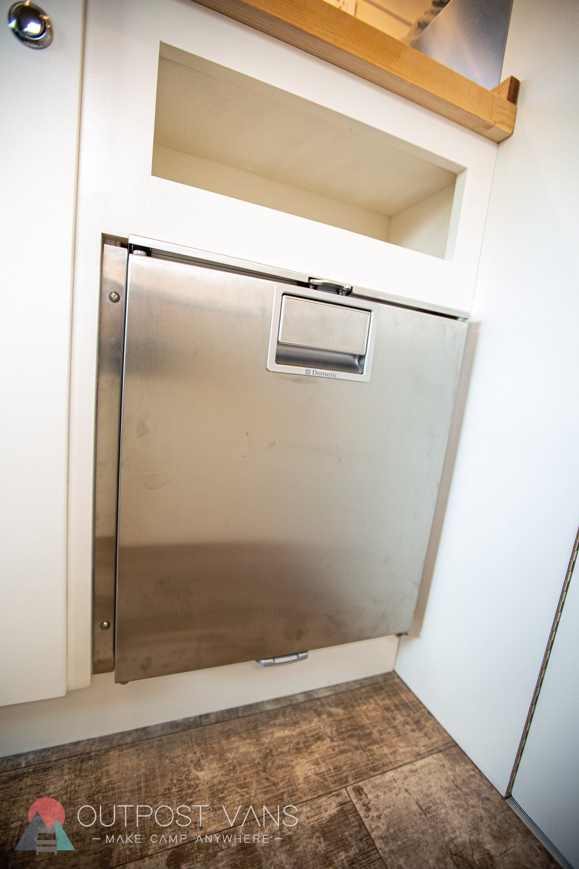 a stainless steel dishwasher is built into a cabinet in a kitchen .