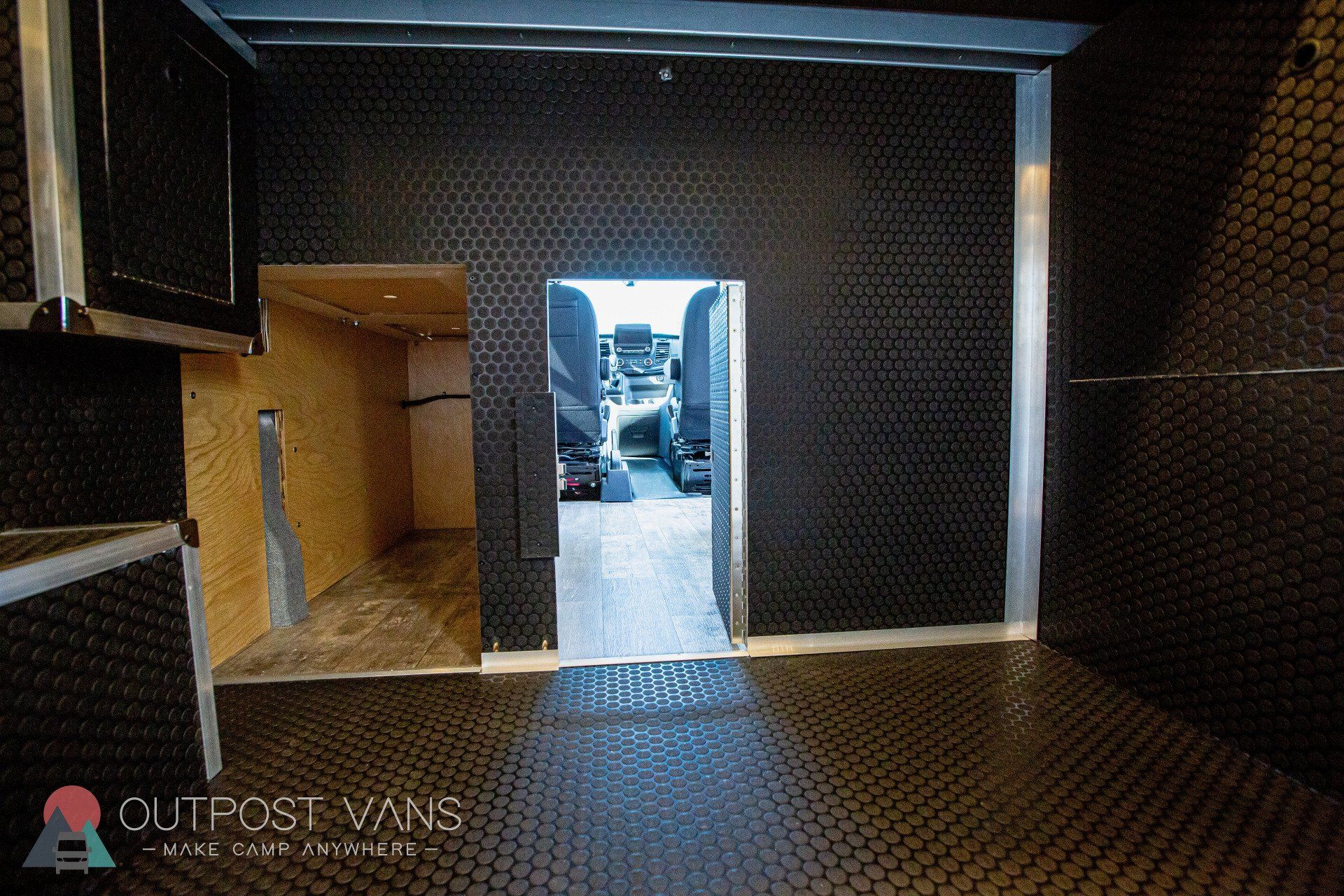 a room with a sliding door that leads to a van .