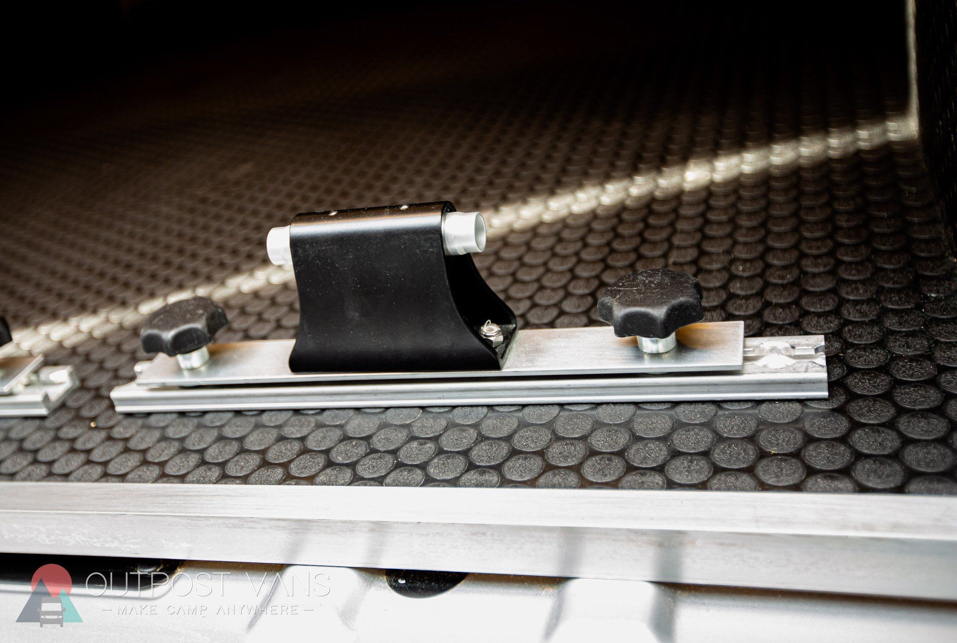 a close up of a bicycle rack on a rubber mat .