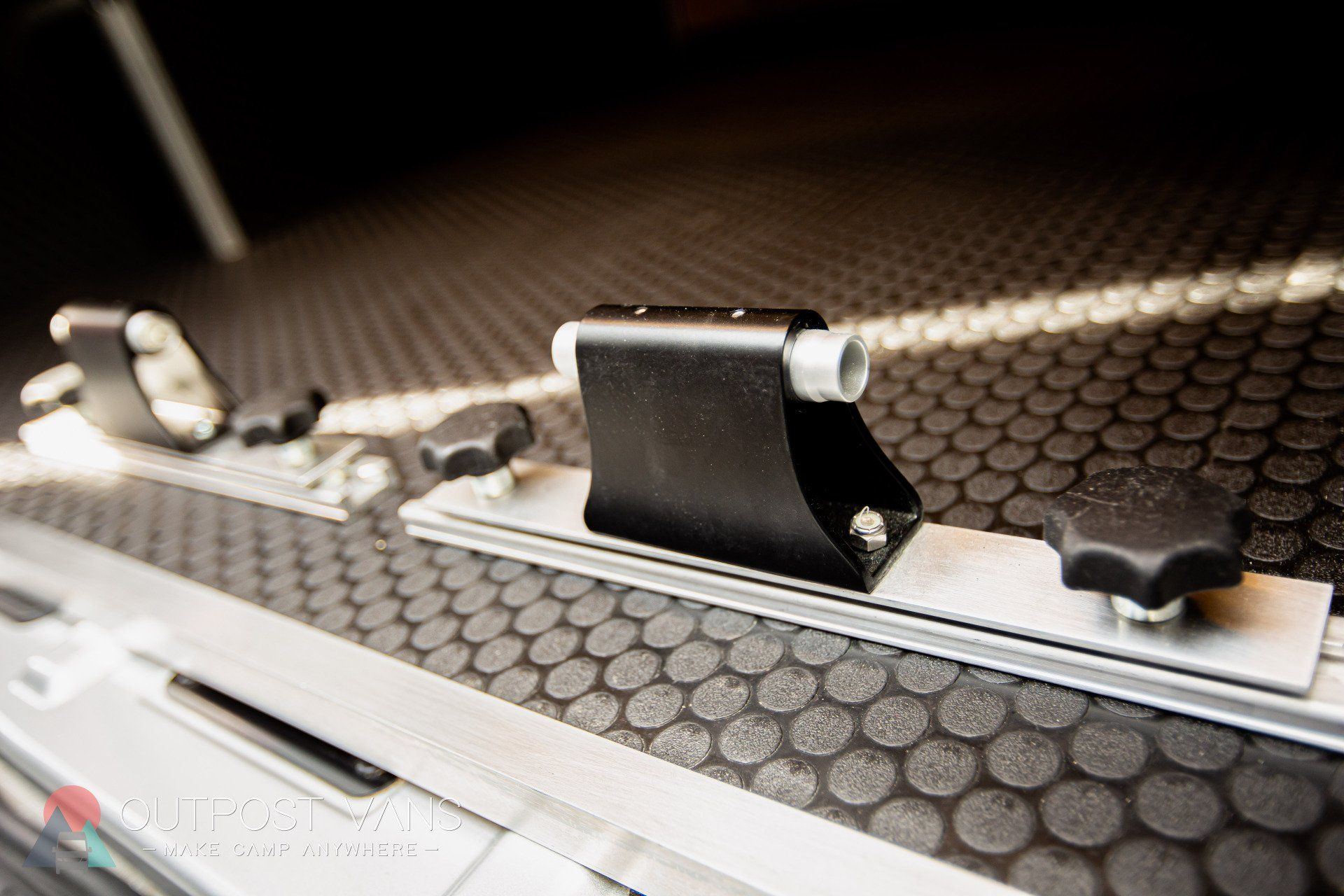 a close up of a metal object on a black rubber mat .