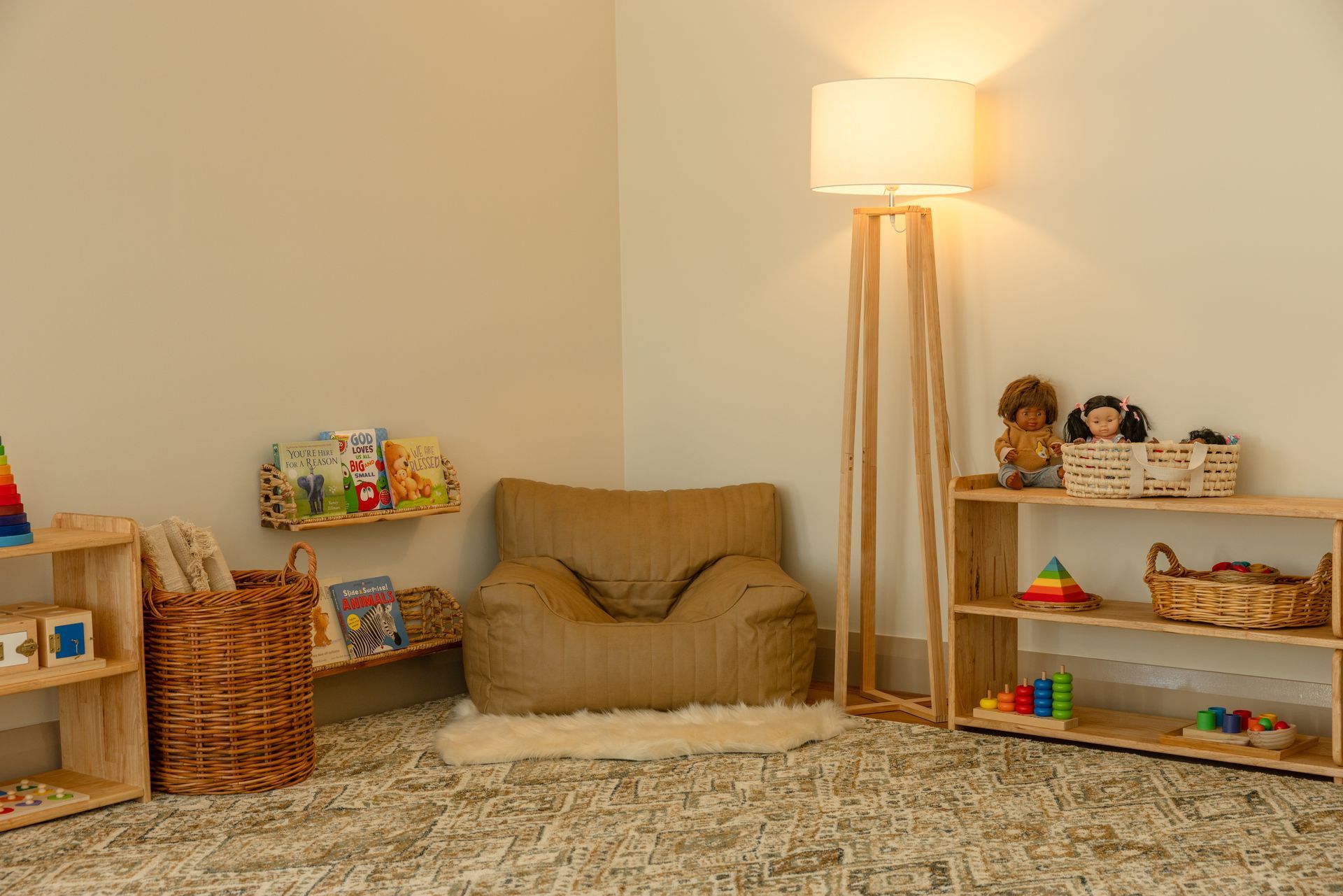 A young boy is enjoying playtime in the sandbox with a bucket and shovel at Tadala Montessori's playground.