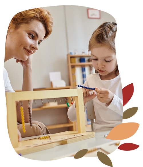 A teacher and child are playing with a wooden frame at Tadala Montessori.