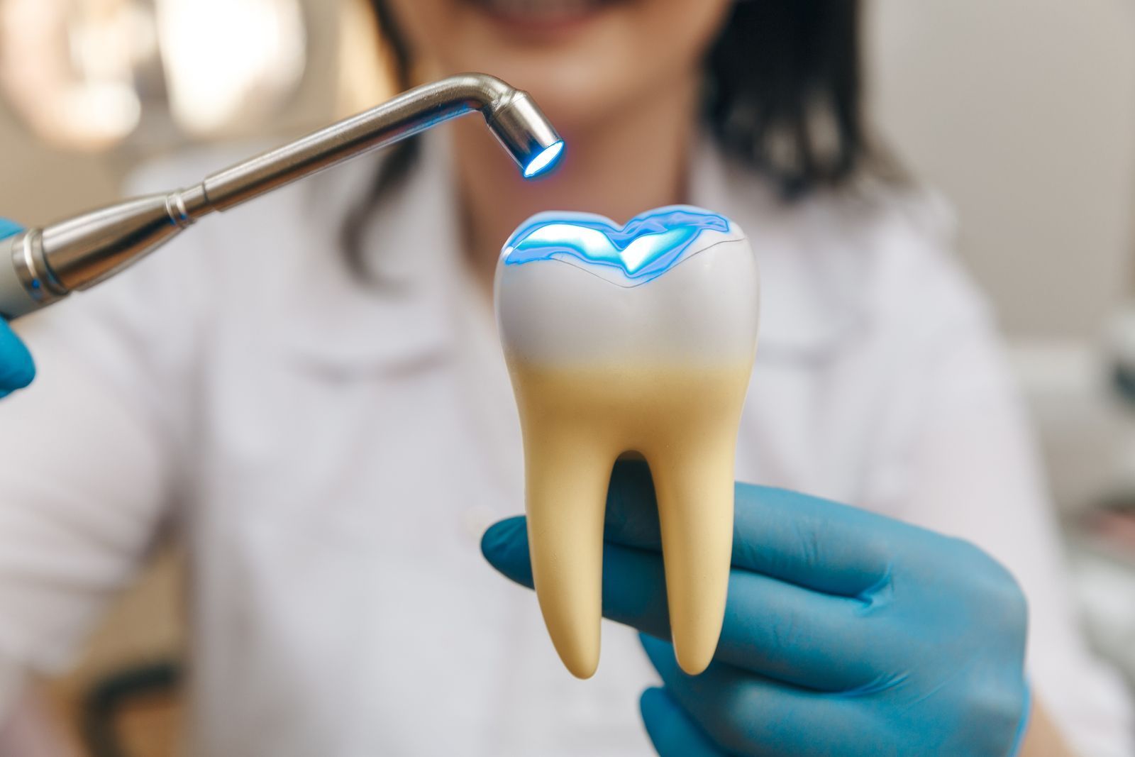 Dentist showing example of dental filling