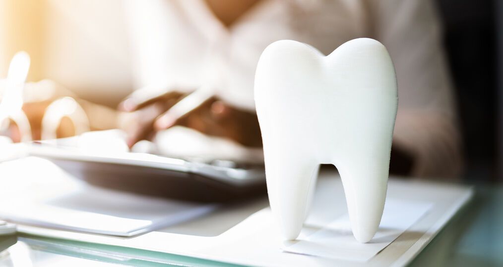 Dentist discussing payment plans with patient in chair