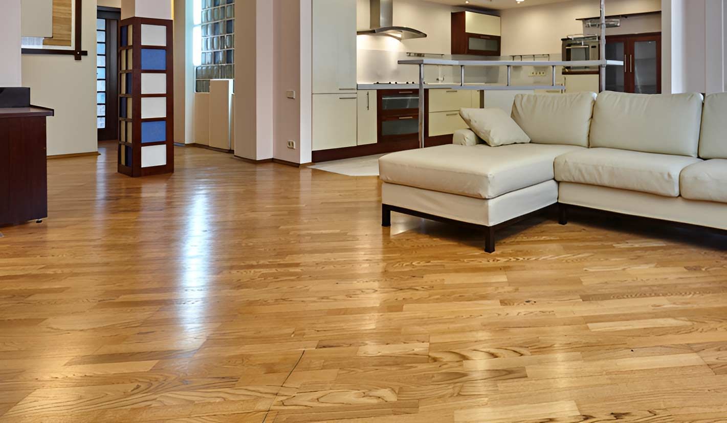 A Living Room Accented By Wooden Floors And A Cozy Couch — Flooring Direct Mid North Coast in South West Rocks, NSW