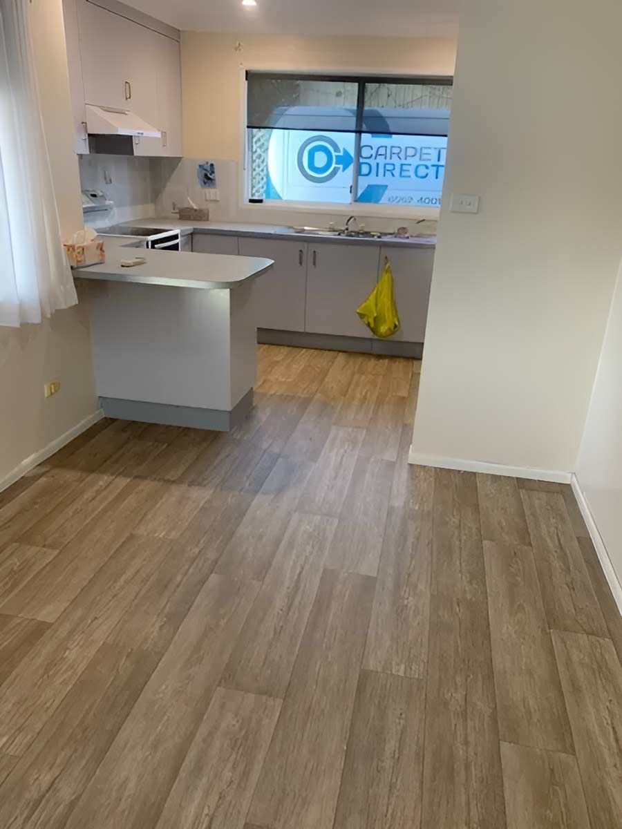 A Kitchen With A Wooden Floor And A Window — Flooring Direct Mid North Coast in South Kempsey, NSW