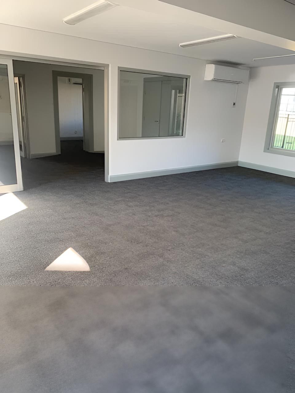 Empty Room With A Gray Carpet — Flooring Direct Mid North Coast in South Kempsey, NSW