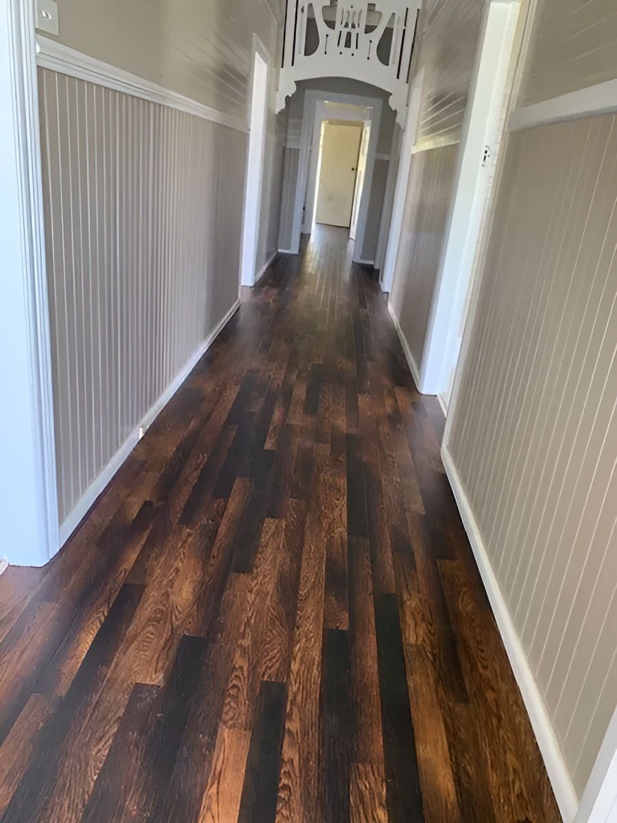 A Wide Hallway With Sleek Wooden Flooring — Flooring Direct Mid North Coast in Frederickton, NSW