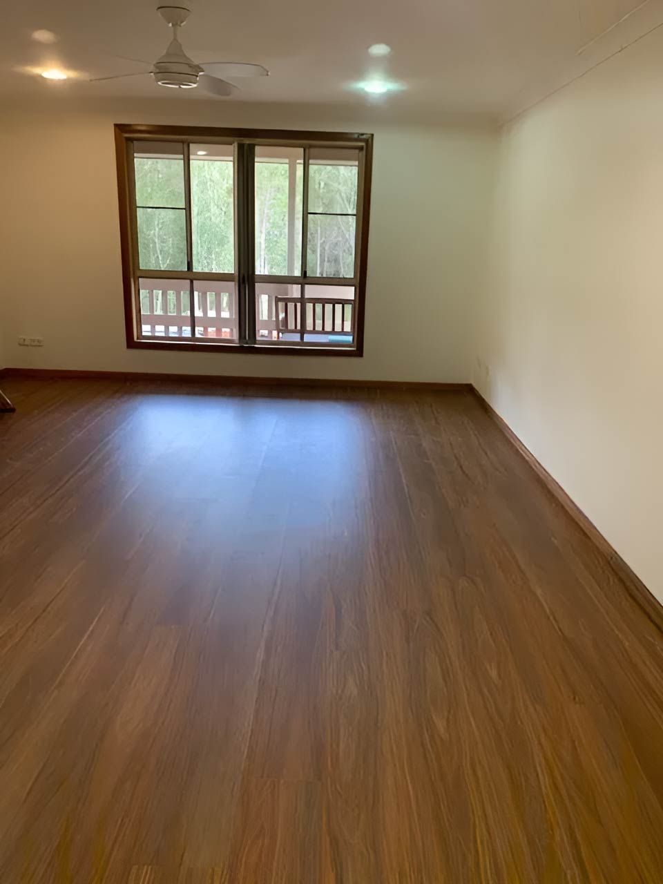 Empty Living Room With Vinyl Floors, Ceiling Fan And Light
— Flooring Direct Mid North Coast in Frederickton, NSW