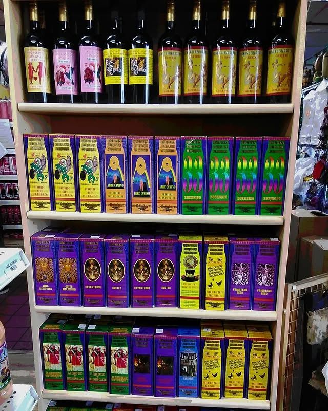 Shelves stocked with various bottles of wine and boxes of incense in a retail store setting.