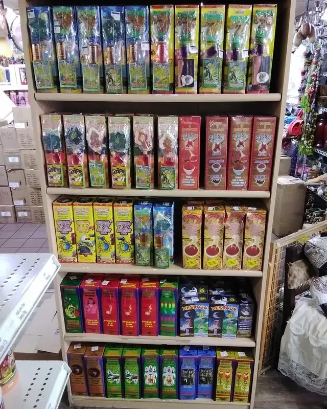 Wooden shelf filled with colorful incense boxes in a retail store.