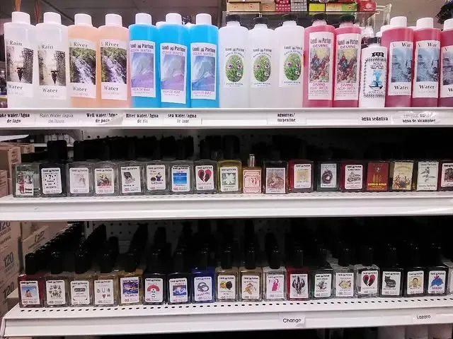 Shelves stocked with various bottles of liquid products, including skincare and other goods, in a store.