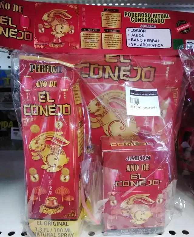 Package with red bottles and boxes featuring a golden rabbit, labeled