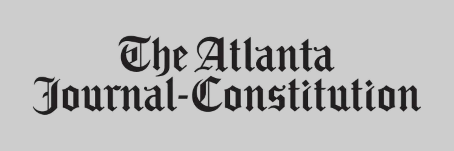 The Atlanta Journal-Constitution logo on a gray background. Black Old English text.
