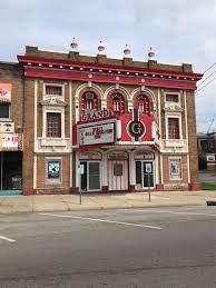 Grand Theater building with red and white facade. Marquee displays a show title. Du Quoin, Il main street. Grand theatre Du Quoin, Il