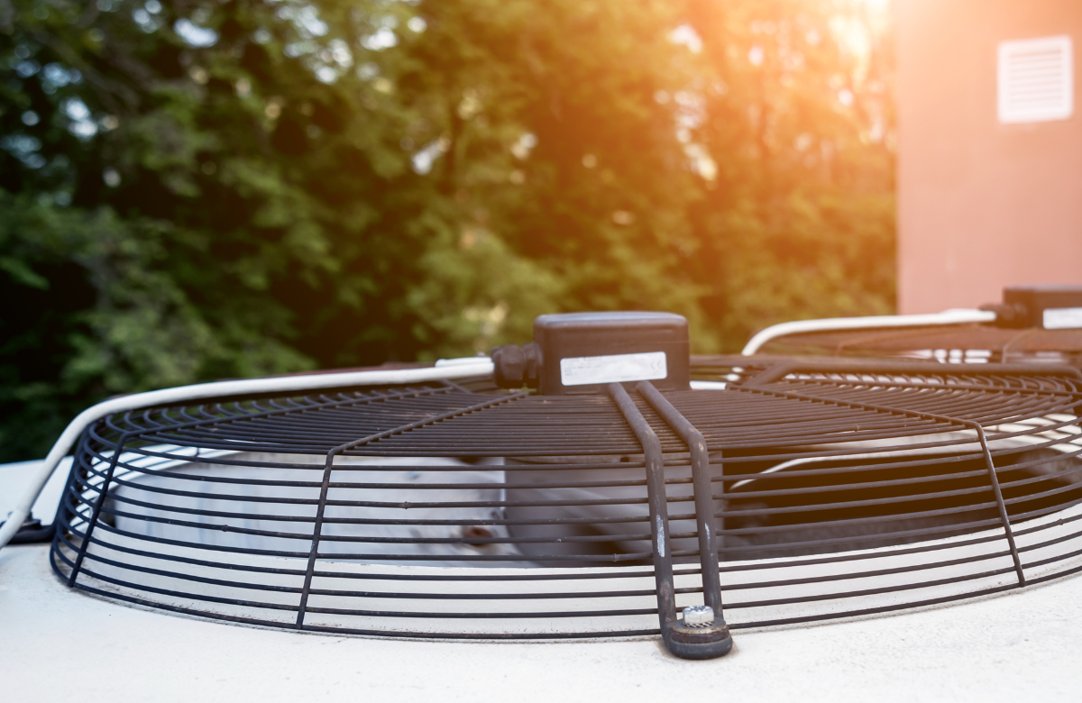 A close up of a fan on top of a building.