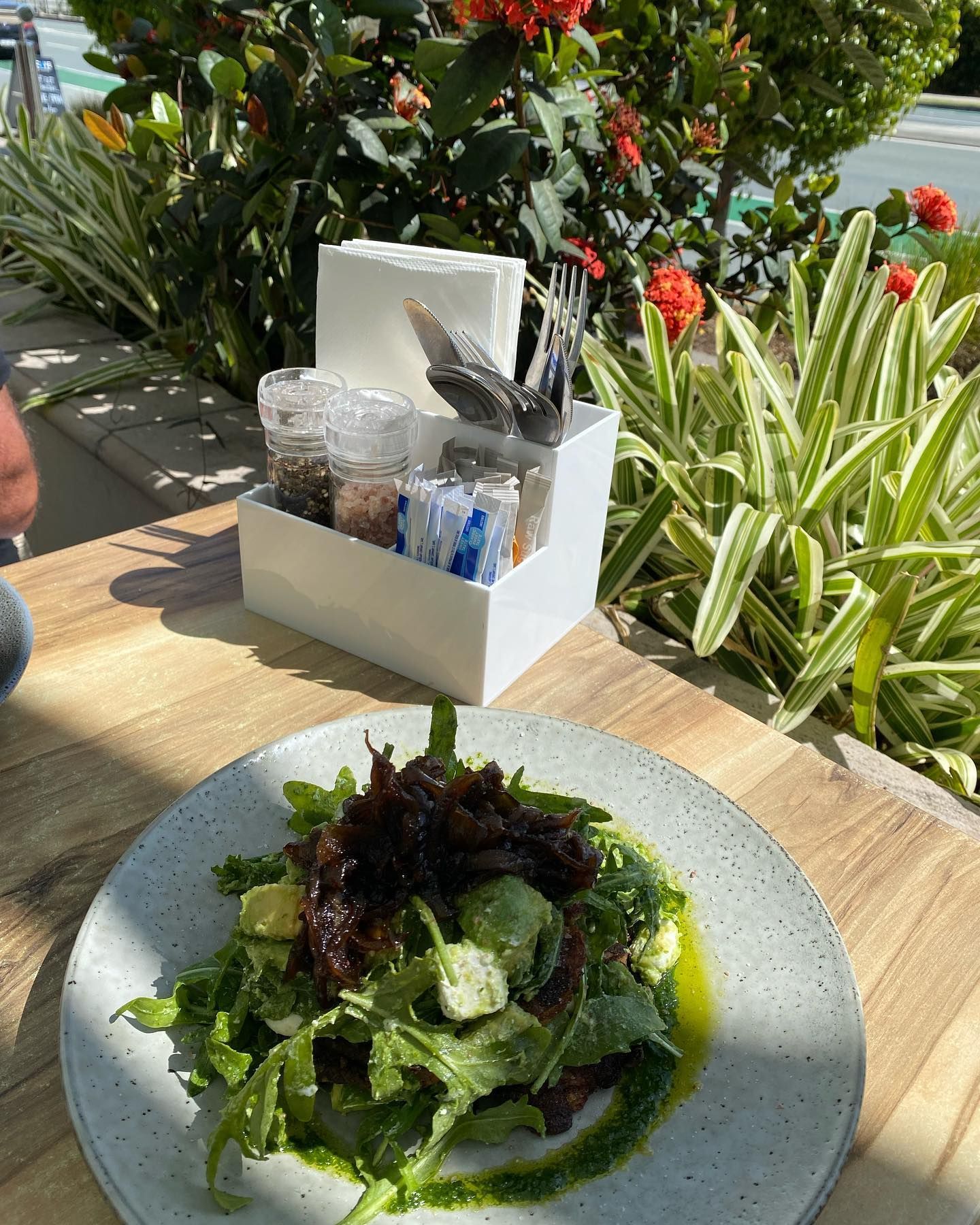 A Plate of Salad is Sitting on a Wooden Table — Bent Plastics in Kunda Park, QLD
