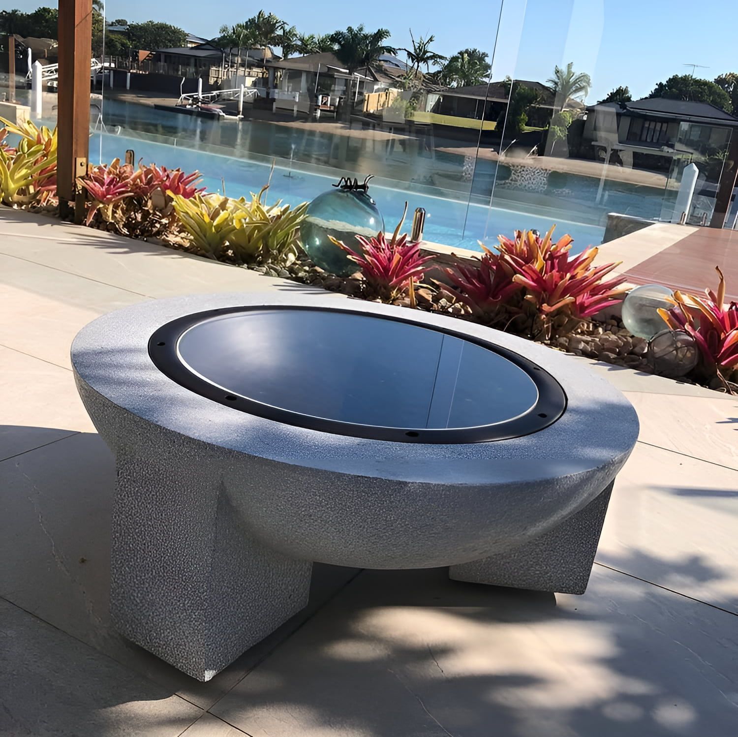 A Fire Pit is Sitting in Front of a Swimming Pool — Bent Plastics in Maroochydore, QLD