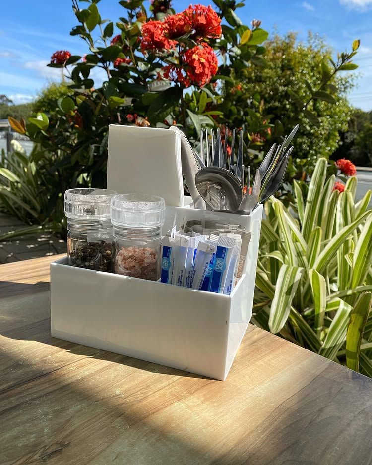 A White Box Filled With Utensils and Spices is Sitting on a Wooden Table — Bent Plastics in Kunda Park, QLD