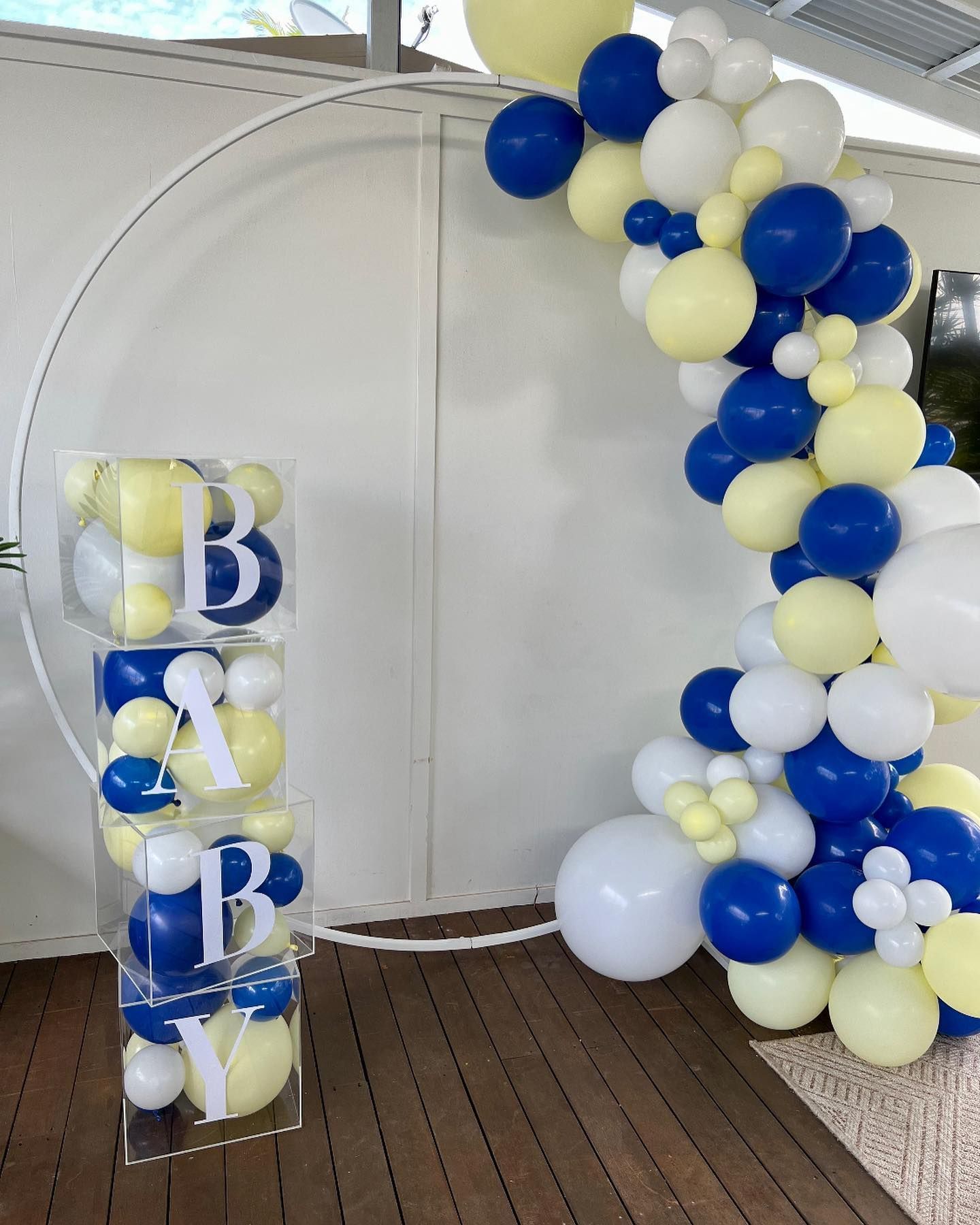 A Bunch of Blue and Yellow Balloons Are Sitting on a Wooden Floor — Bent Plastics in Kunda Park, QLD