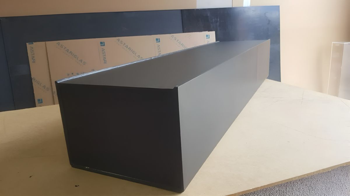 A Black Box Is Sitting On Top Of A Wooden Table — Bent Plastics in Maroochydore, QLD