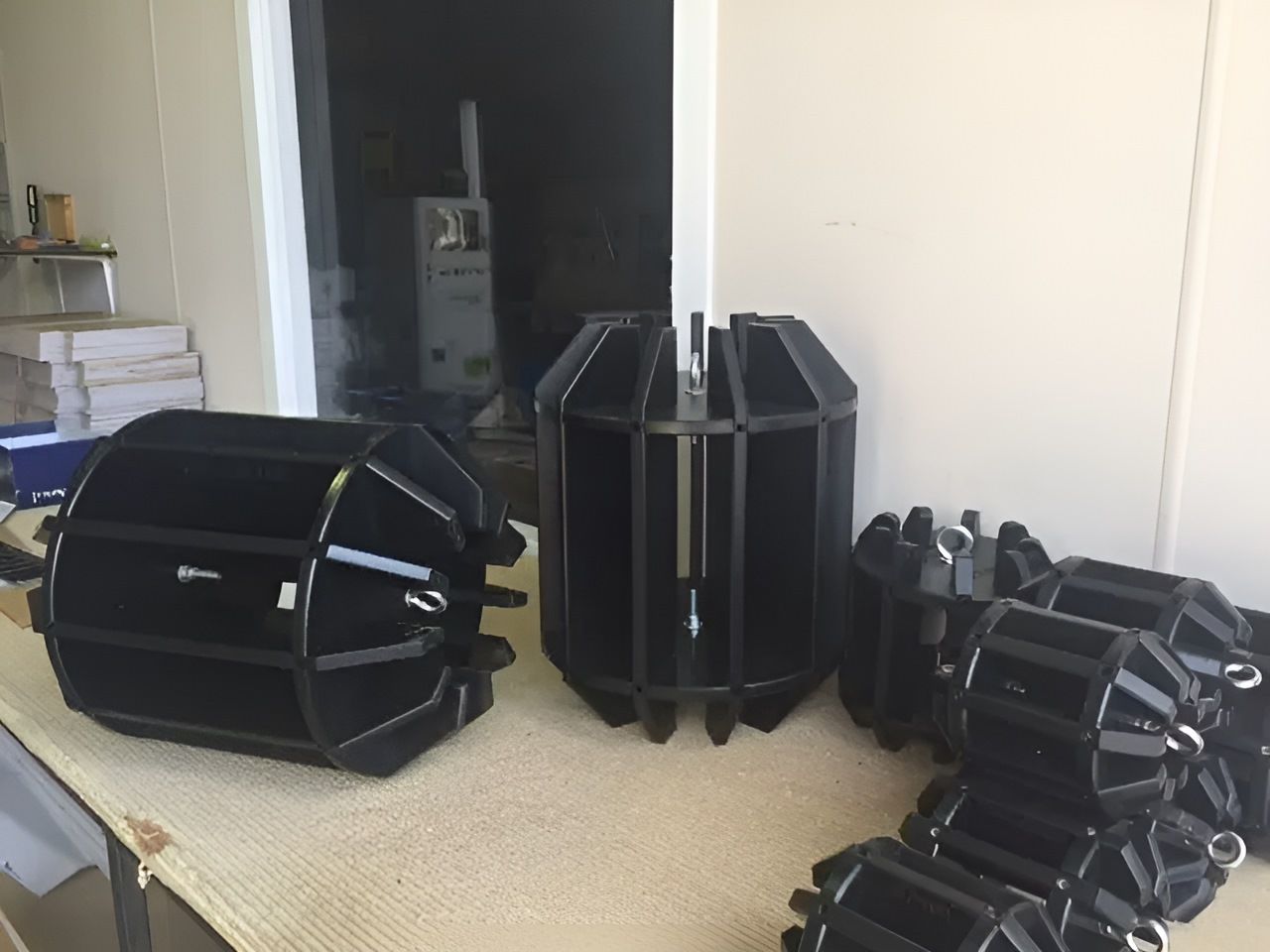 A Bunch Of Black Objects Are Sitting On A Table — Bent Plastics in Kunda Park, QLD