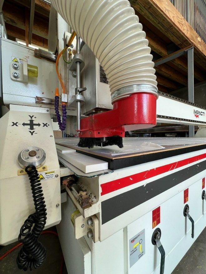 A Machine With a Hose Attached to It is Cutting a Piece of Wood — Bent Plastics in Kunda Park, QLD