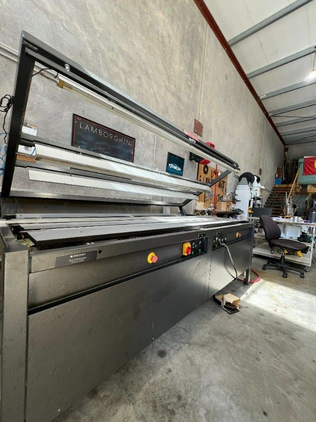 A Large Stainless Steel Machine is Sitting in a Room — Bent Plastics in Kunda Park, QLD