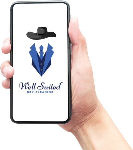 a hand is holding a cell phone with the well suited dry cleaning logo on it .
