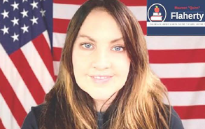 A person smiling in front of an American flag, with a logo in the top right corner reading 