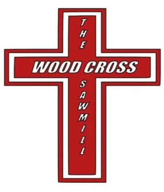 Cut pine logs stacked outside, showing growth rings.