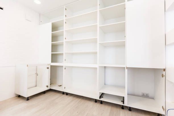 Empty white shelving unit with open doors.