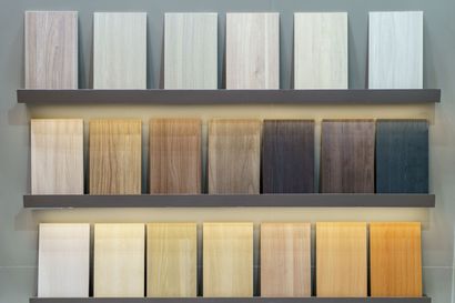 Wooden flooring samples in various colors displayed on shelves.