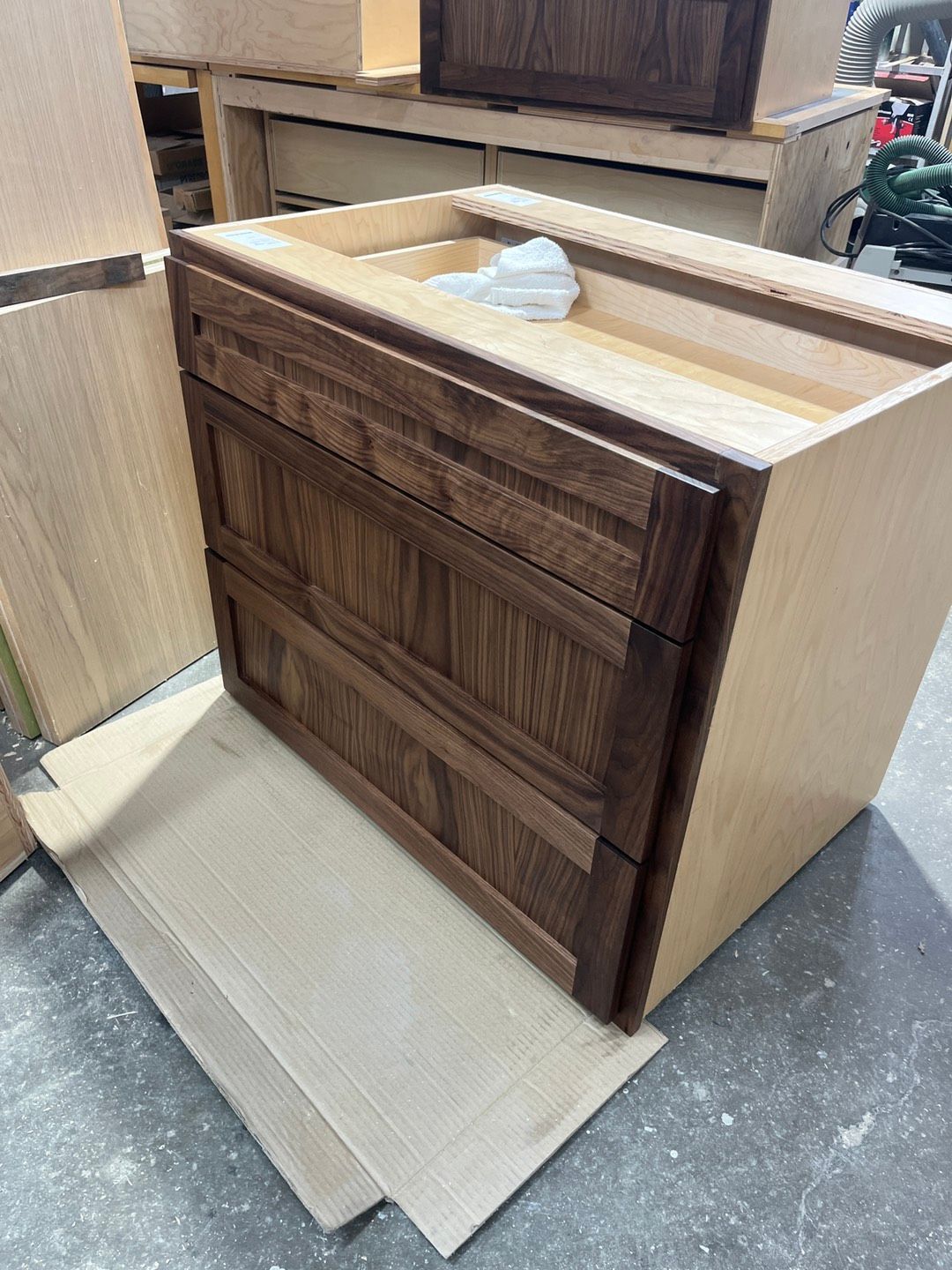 Wooden cabinet with two drawers and a stained brown finish.