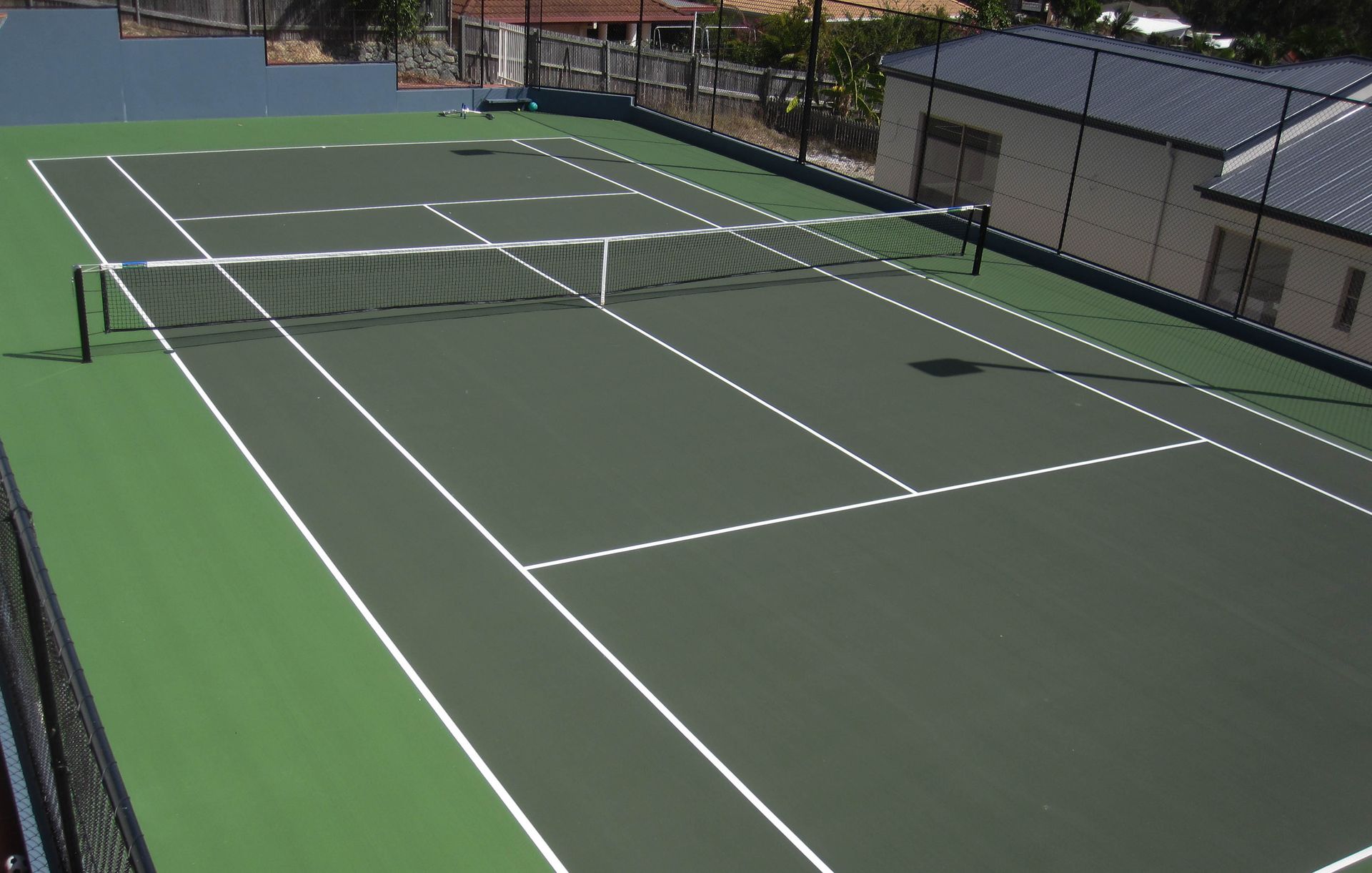 A Green Tennis Court with White Lines and a Net — Queensland, Australia — Jordin Sports Constructions
