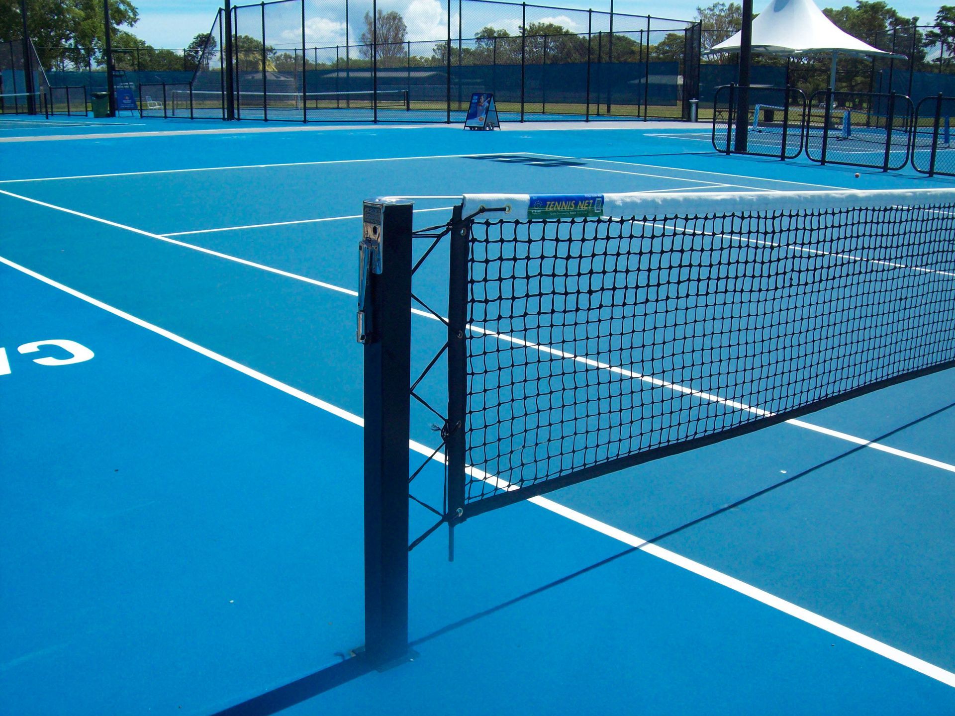 A Blue Tennis Court with a Number on It — Queensland, Australia — Jordin Sports Constructions
