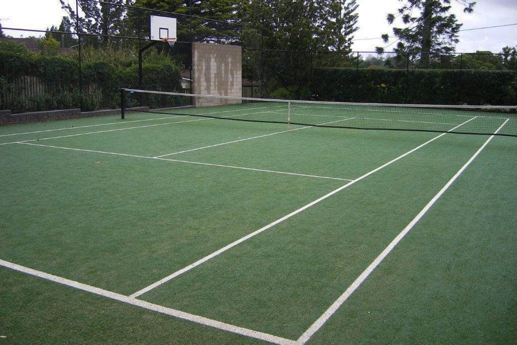 Green Tennis Court with a Basketball Hoop in the Background — Queensland, Australia — Jordin Sports Constructions