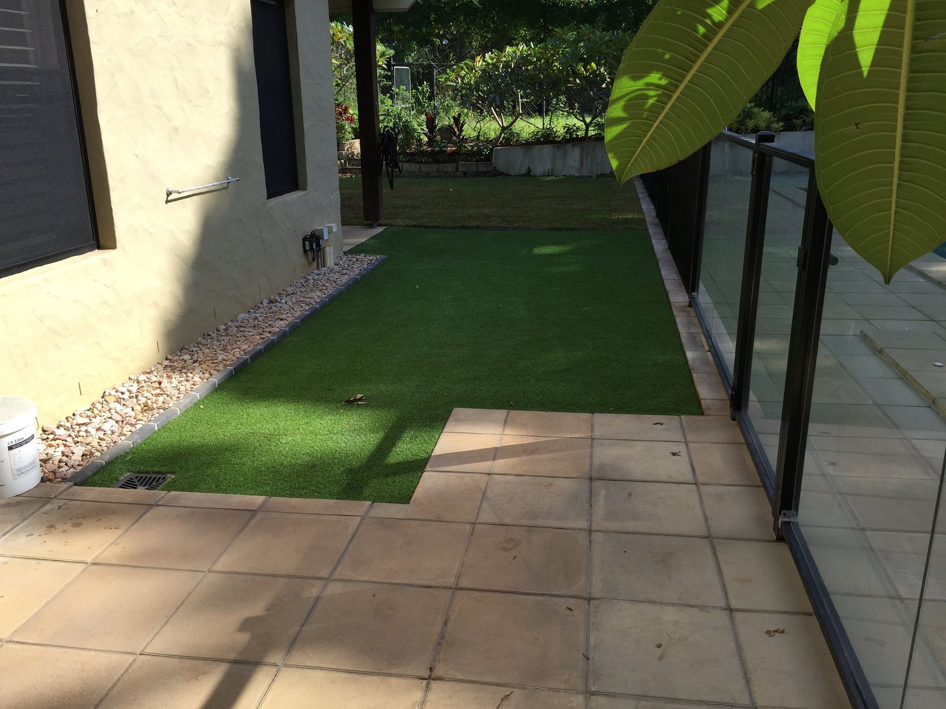 A Patio With a Lush Green Lawn in Front of a House — Queensland, Australia — Jordin Sports Constructions
