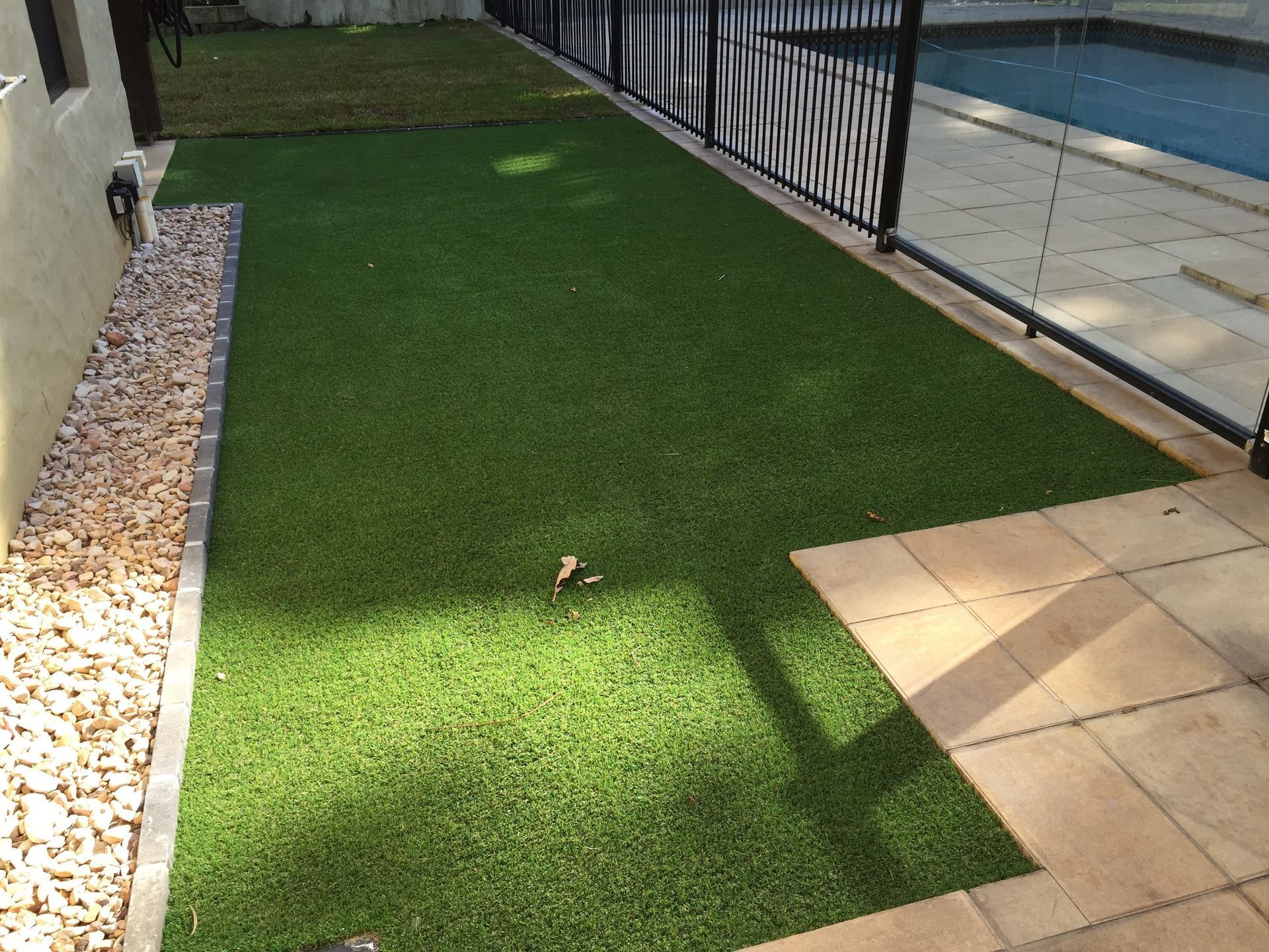 Lawn With a Fence and a Pool in the Background — Queensland, Australia — Jordin Sports Constructions