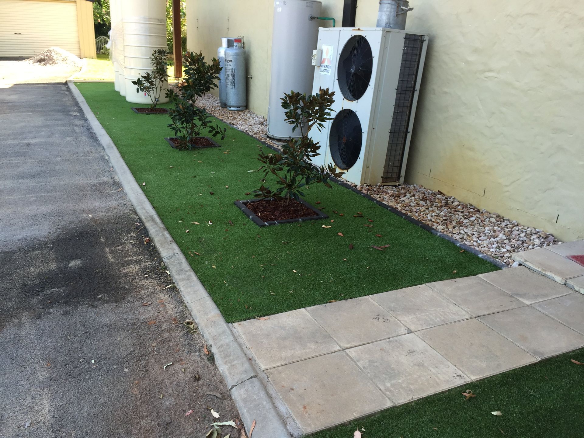 A Sidewalk With Plants and Heater on the Side — Queensland, Australia — Jordin Sports Constructions