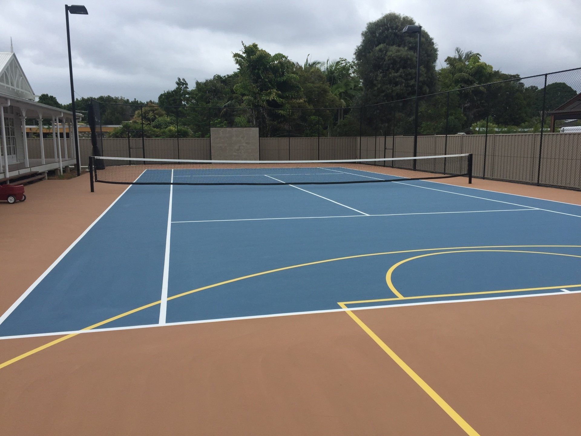 Blue Tennis Court with White and Yellow Line — Queensland, Australia — Jordin Sports Constructions